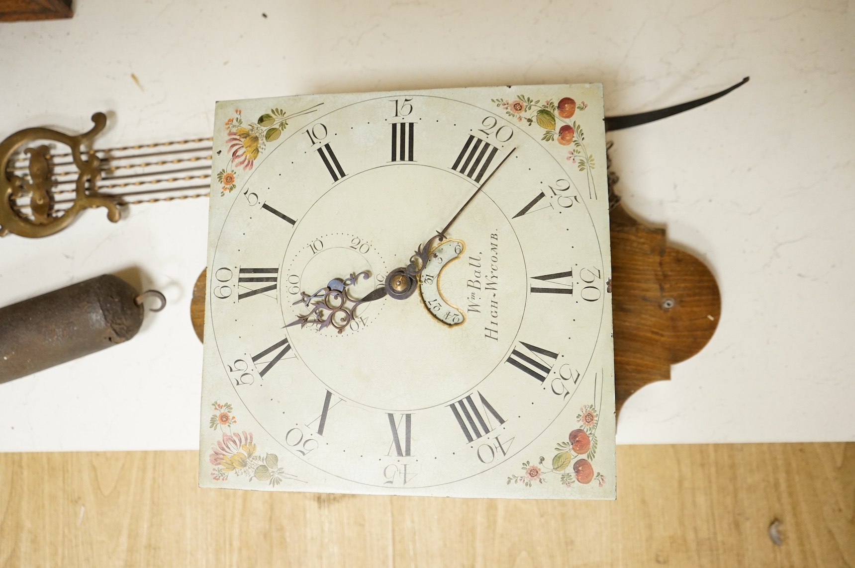 A 19th century wall clock with pendulum and weight, the floral dial inscribed Wm Ball, High Wycombe